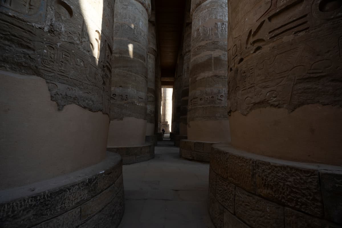 Massive ancient columns in a dimly lit hall