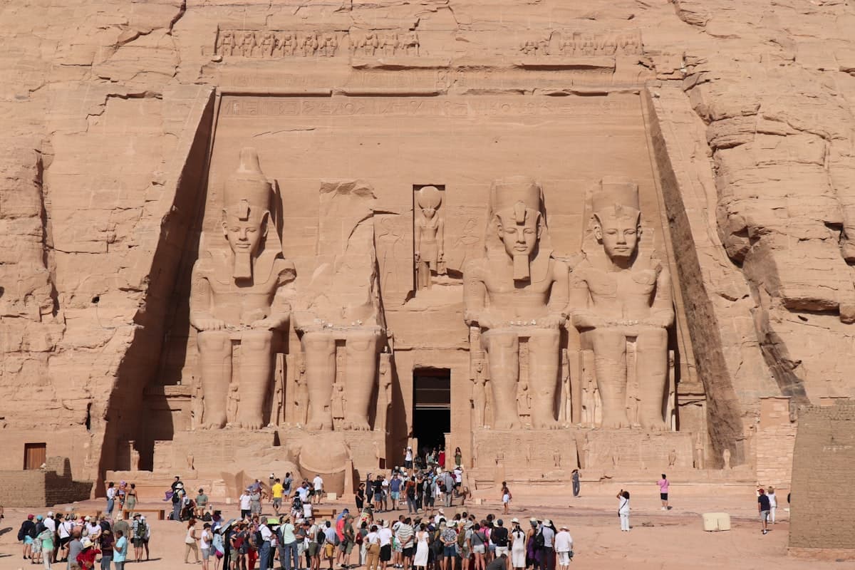 Massive ancient statues carved into a rock face