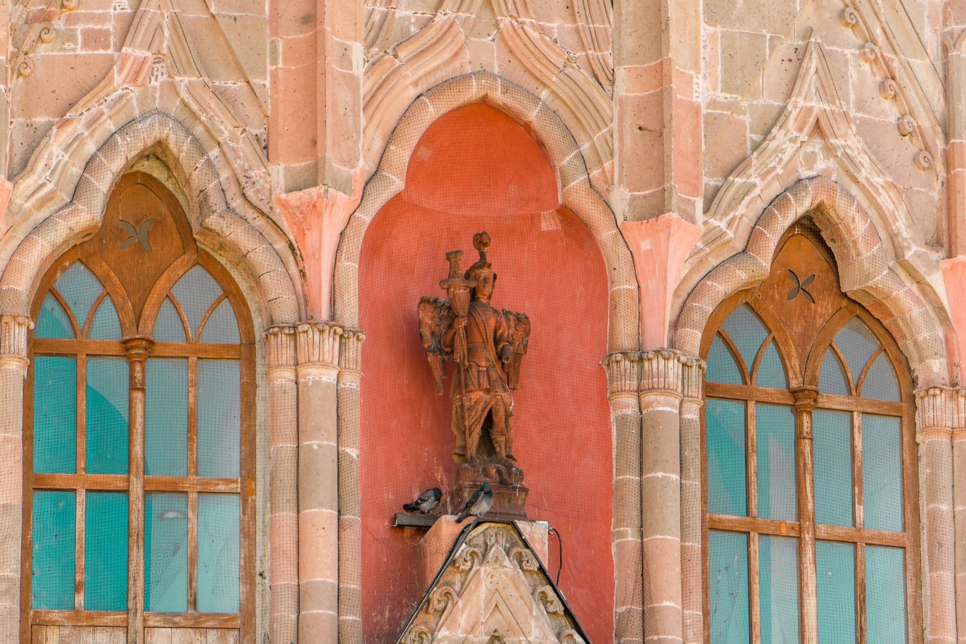 A detailed view of Parroquia de San Miguel Arcángel's Gothic architecture in vibrant San Miguel de Allende.
