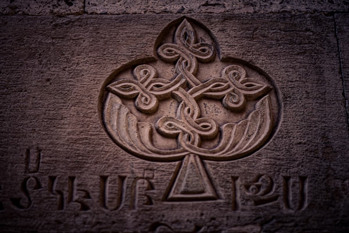 A close up of a stone with a cross on it