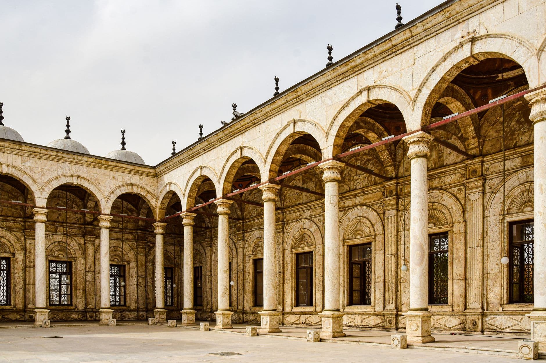 Exploring the iconic arches and columns of the Citadel's alabaster mosque in Cairo's Islamic architecture.