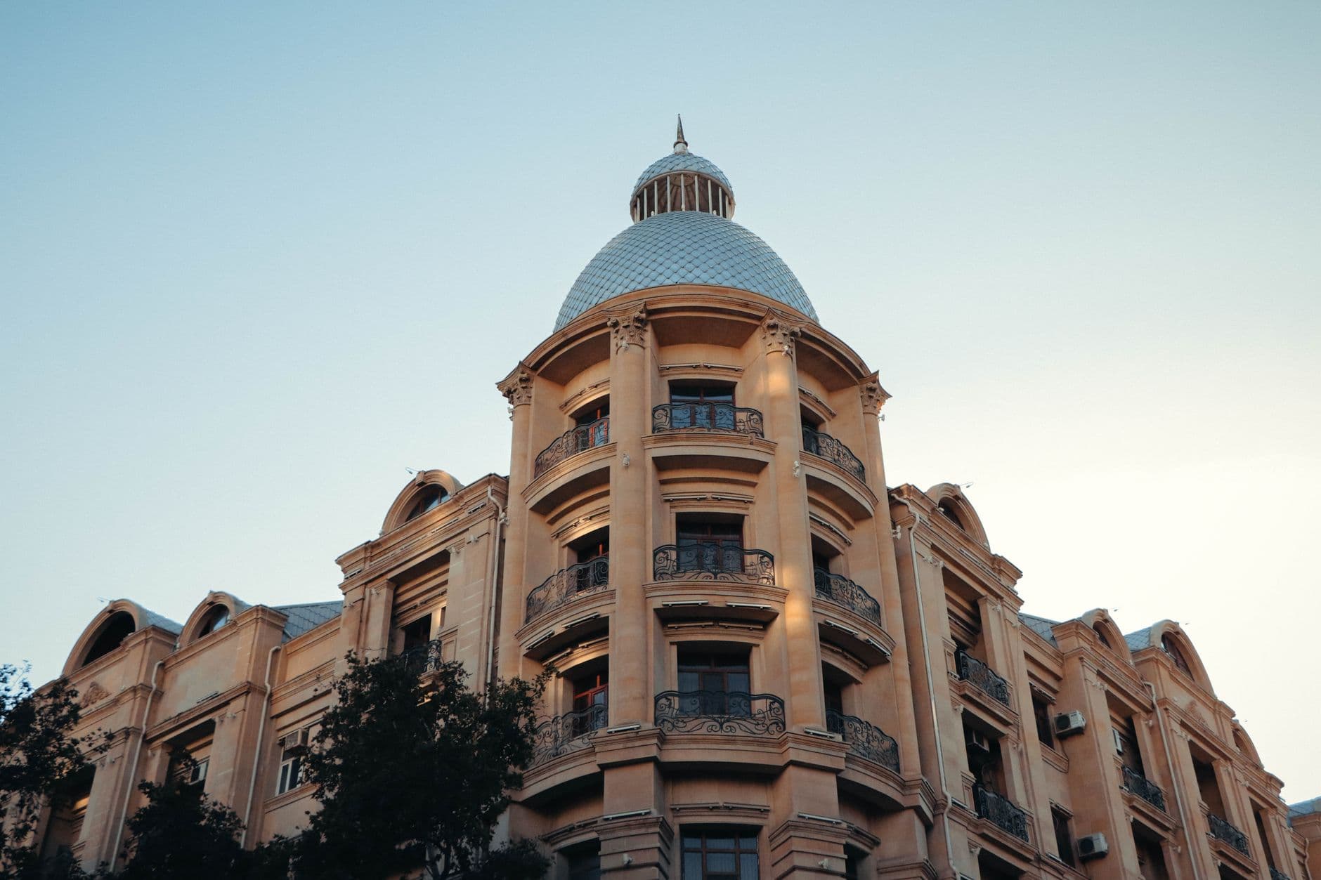 Elegant architectural facade in Baku, Azerbaijan, captured at dusk with a clear sky.