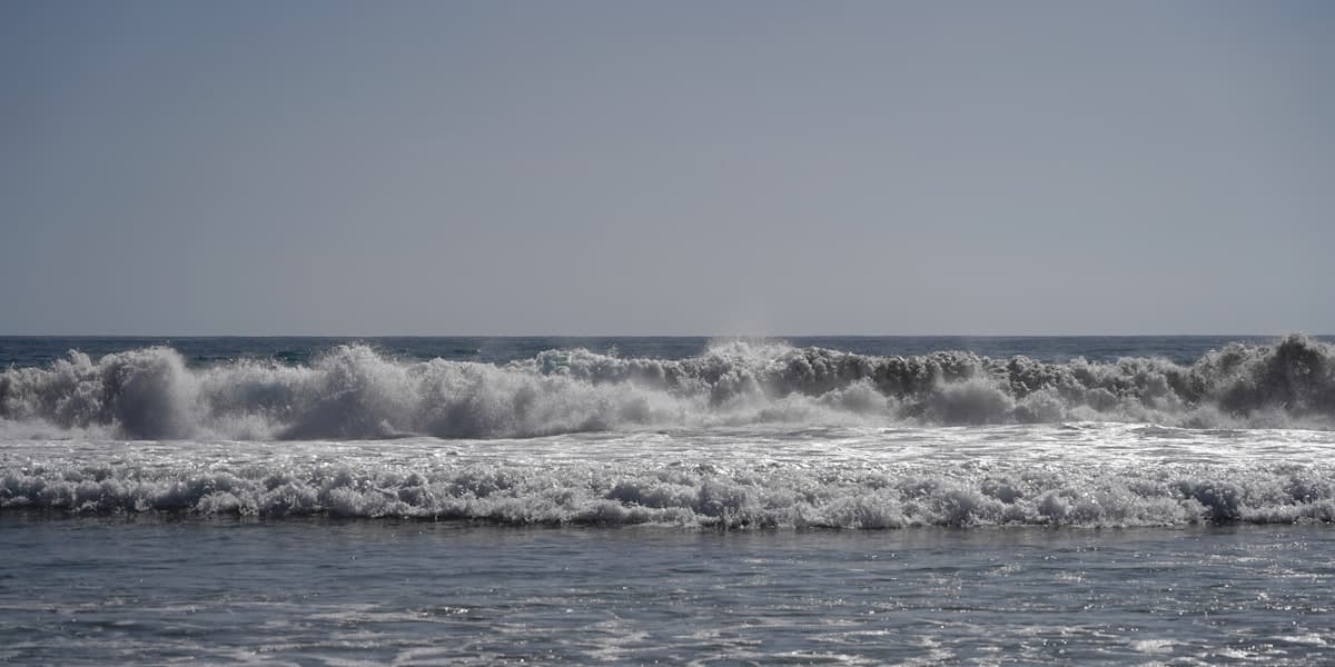 a large body of water with a wave coming in