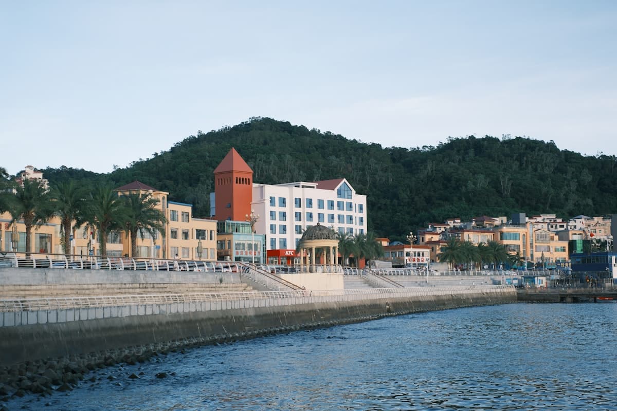 Coastal town with buildings and a hill