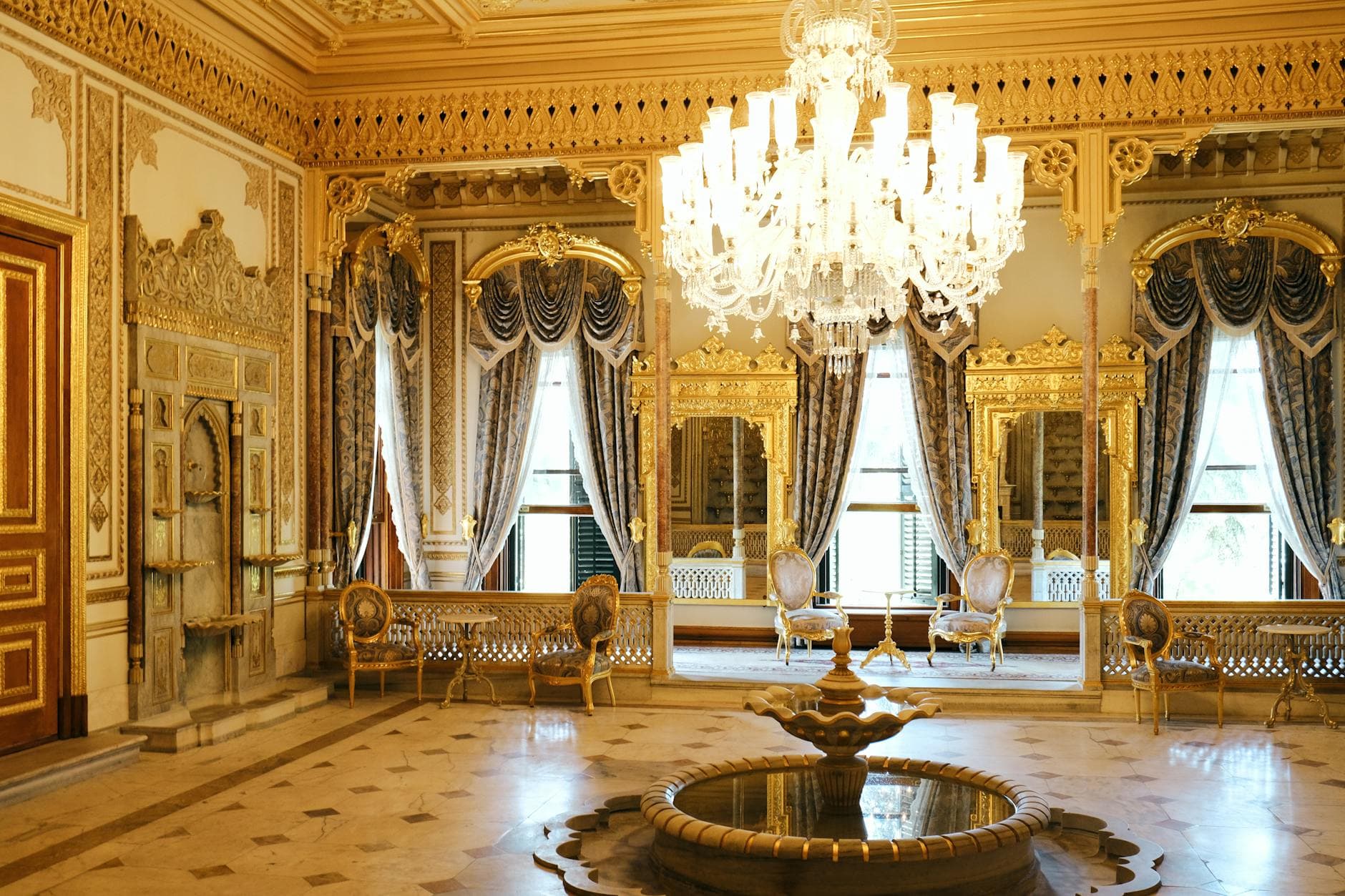 Lavishly decorated palace room with gold accents and elegant chandeliers in Istanbul, Turkey.