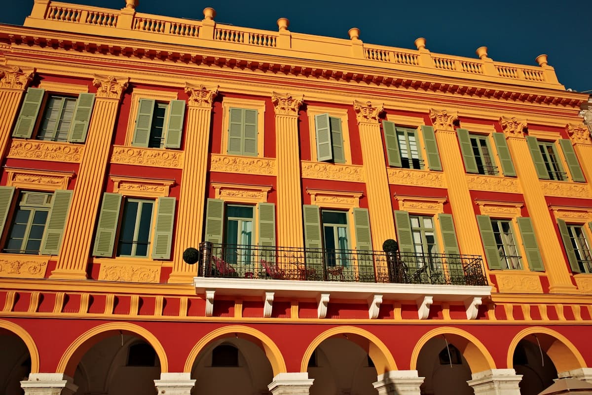 A large yellow building with green shutters