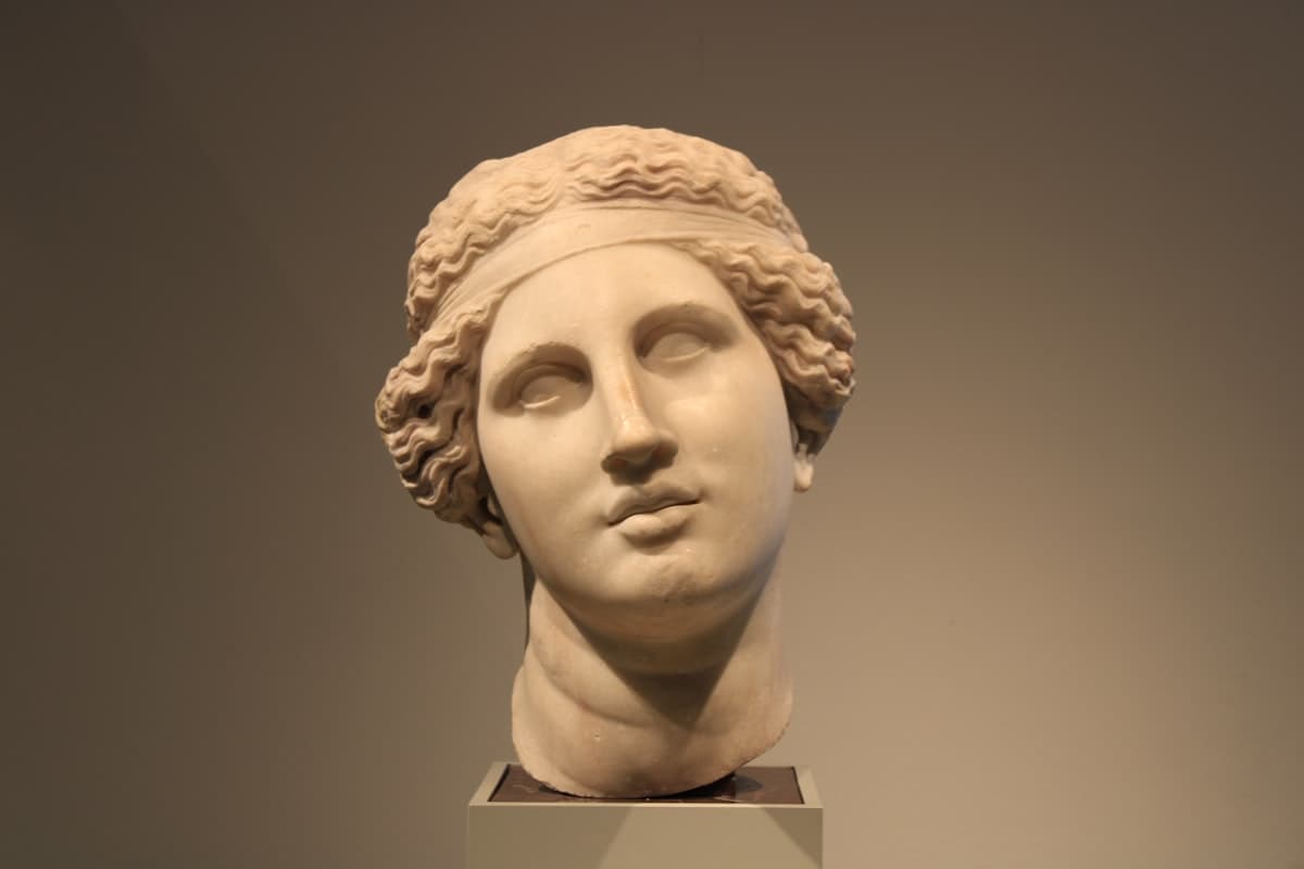 Marble bust of a woman with curly hair