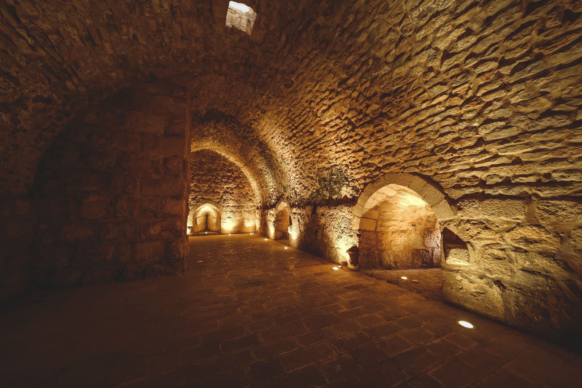 Explore this mysterious ancient stone tunnel with soft ambient lighting and historic atmosphere.