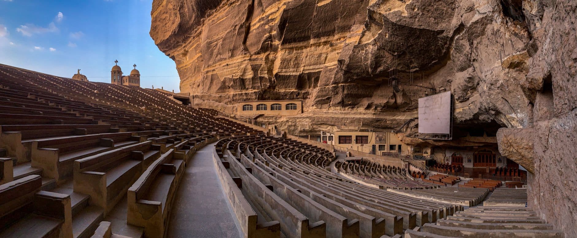 Panoramic view of St. Simon the Tanner Monastery's cave church seating area in Cairo, Egypt.