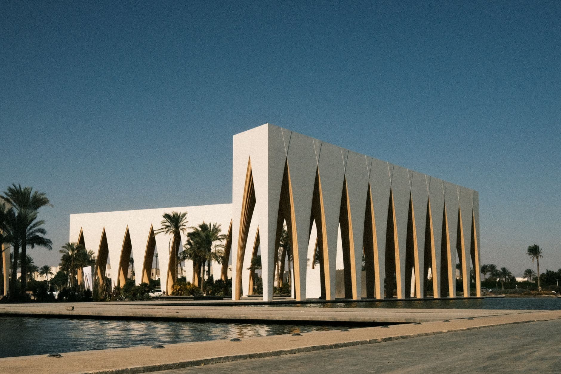 Captivating view of a modern architectural landmark at El Gouna Festival Plaza, surrounded by palm trees.