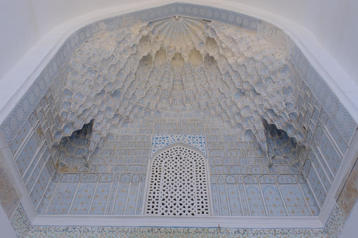 a white and blue building with a decorative window