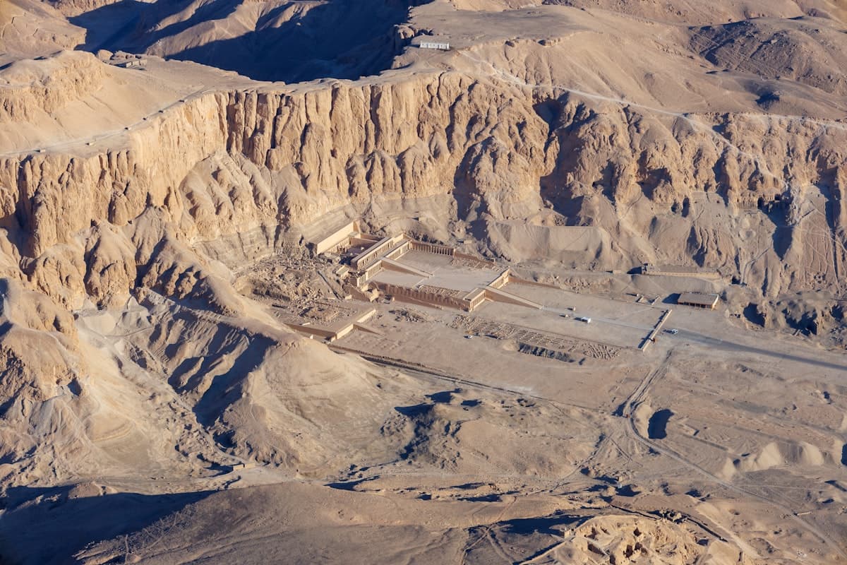 An aerial view of a desert with mountains in the background