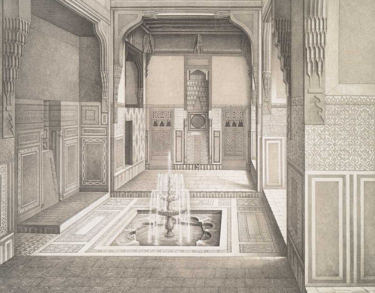 Ornate interior courtyard with a central fountain and intricate carvings.