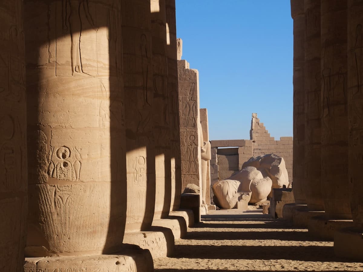 Ancient egyptian columns with hieroglyphs and statues