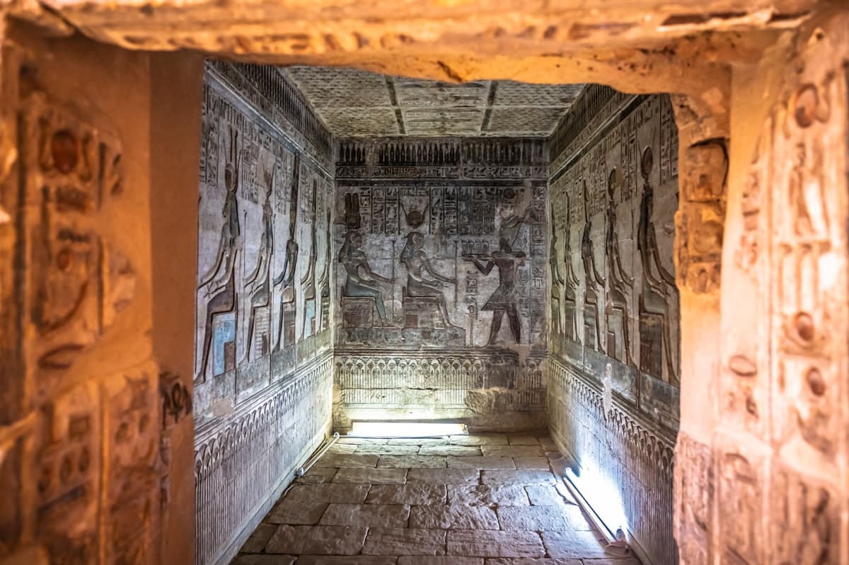 A long narrow hallway with carvings on the walls