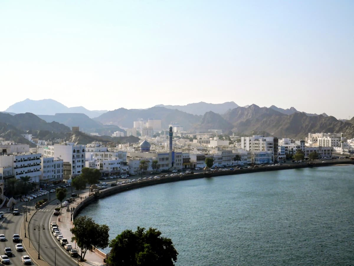 Coastal city with mountains and a bay.