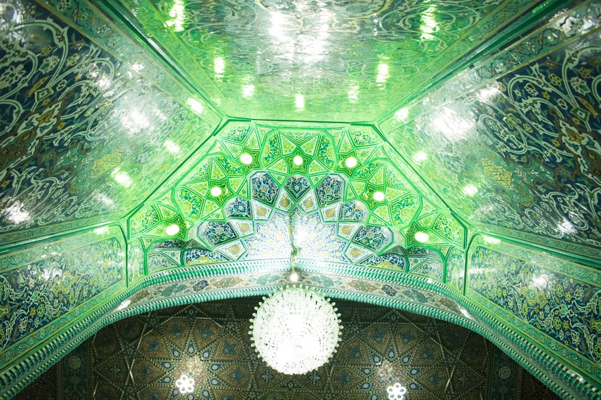 the ceiling of a building with a chandelier hanging from it