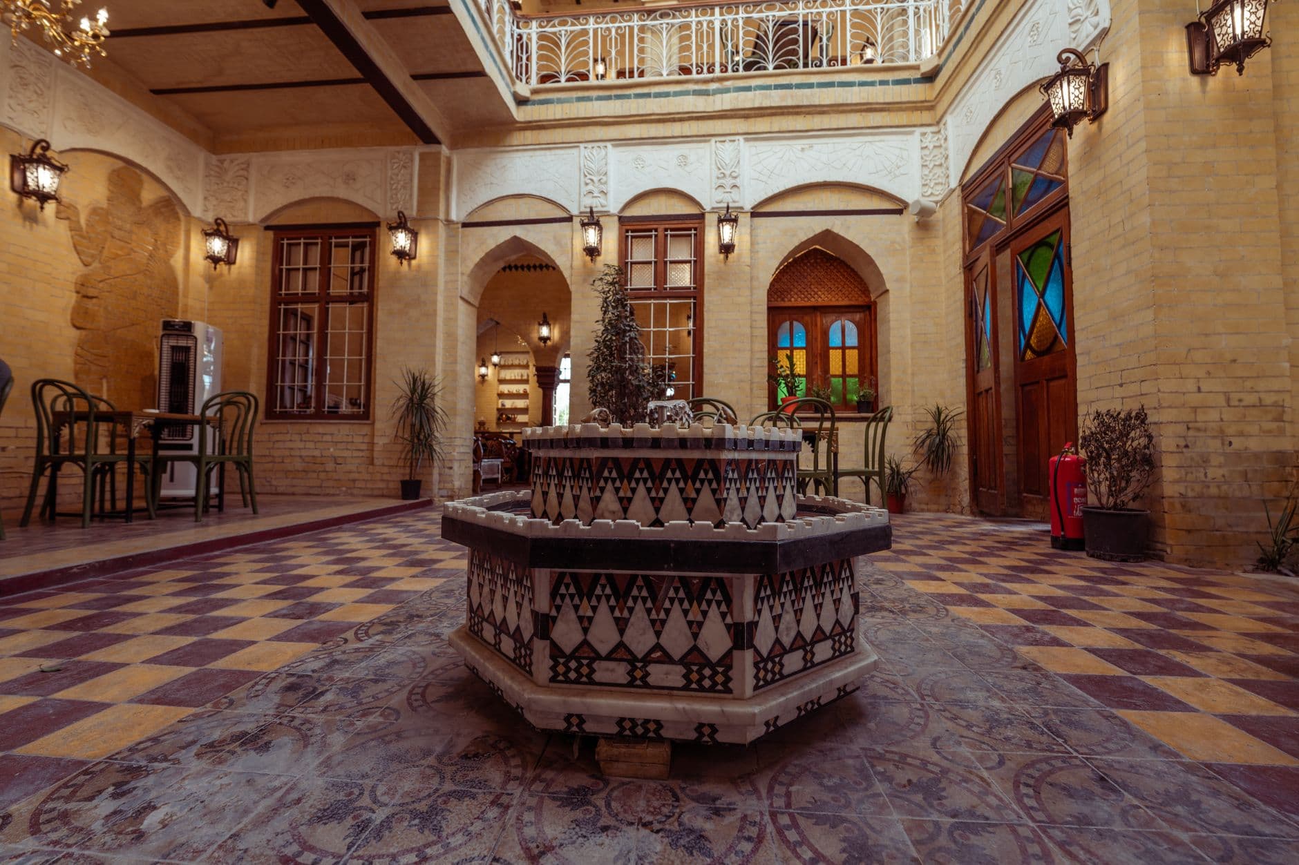 Beautiful traditional courtyard in Baghdad, featuring intricate tile designs and a central fountain.