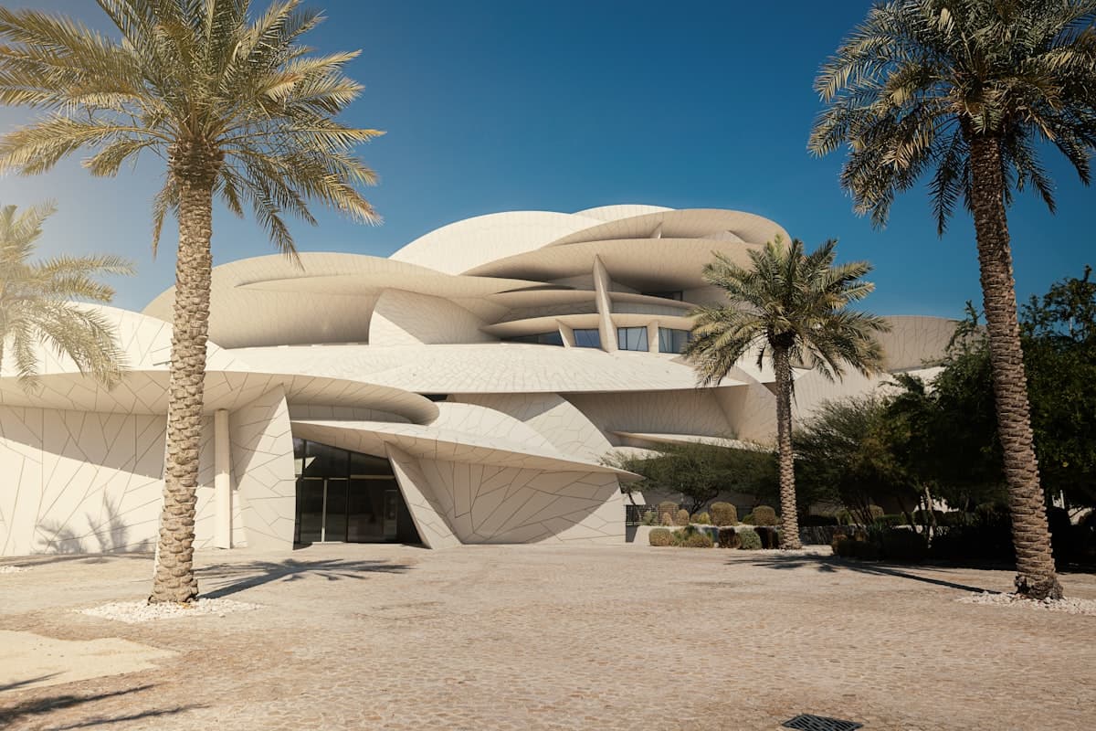 a modern building with palm trees in front of it