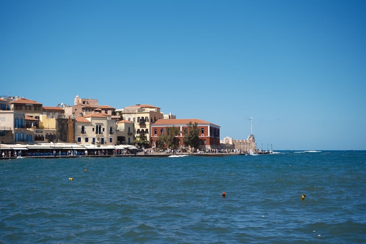 Buildings line the coast with the blue ocean.