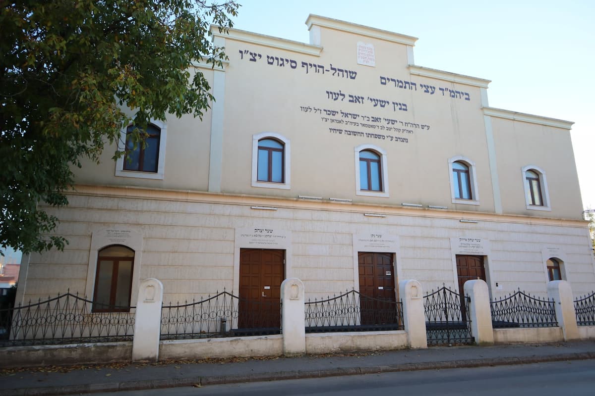 A large white building with a fence around it
