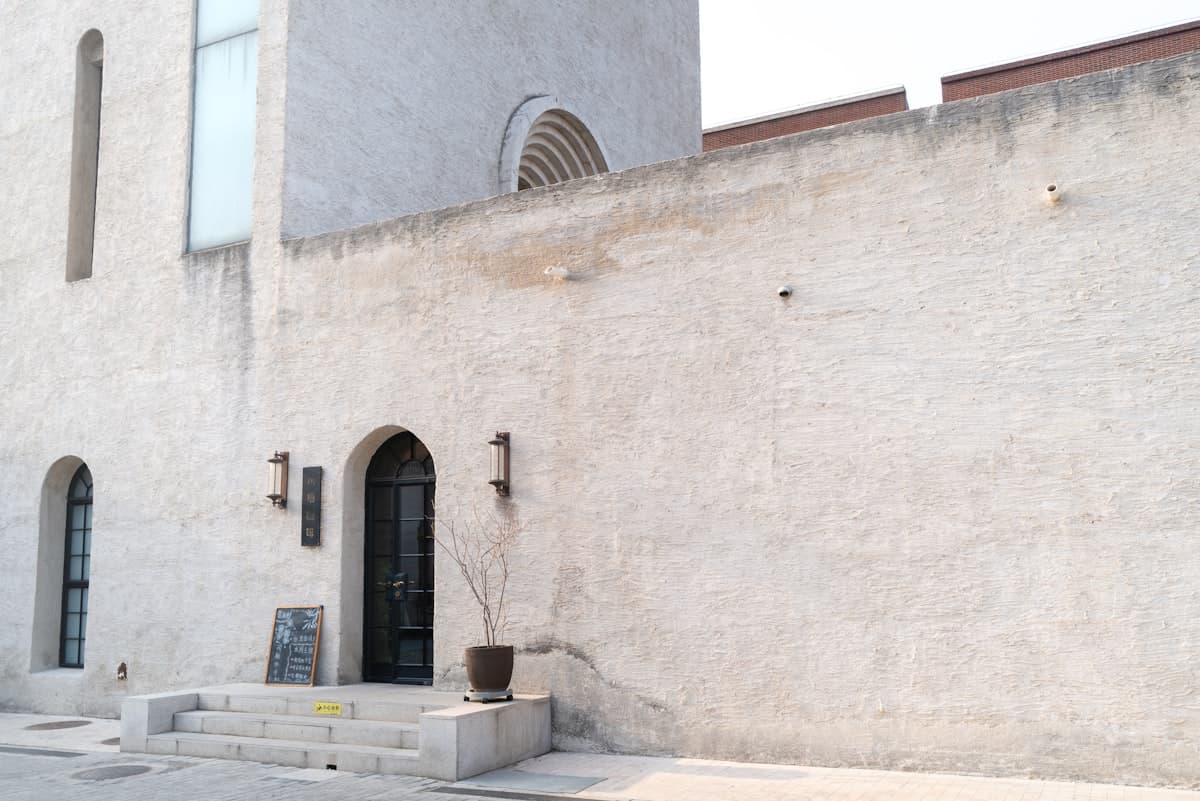 Exterior of a building with arched doorways and windows.