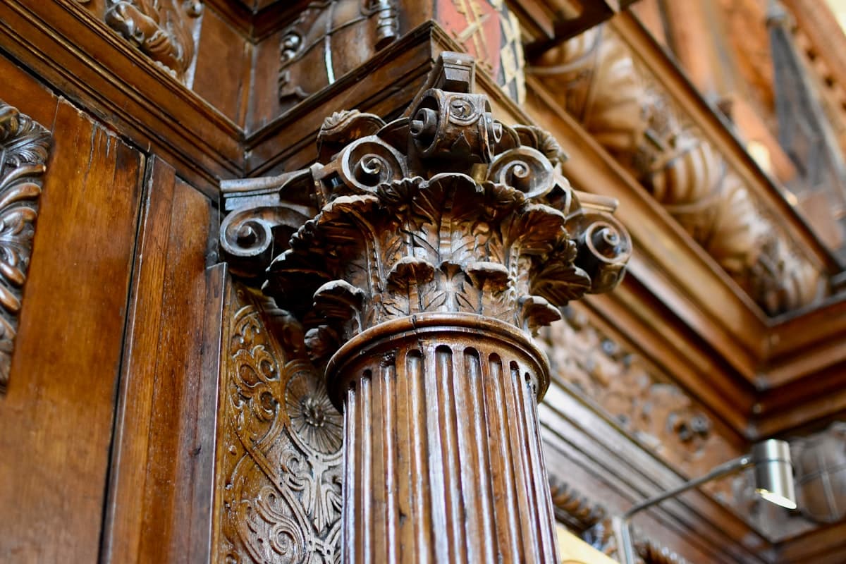 a close up of a wooden pillar with carvings on it
