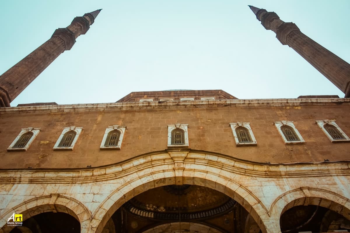 a tall brick building with two stone pillars