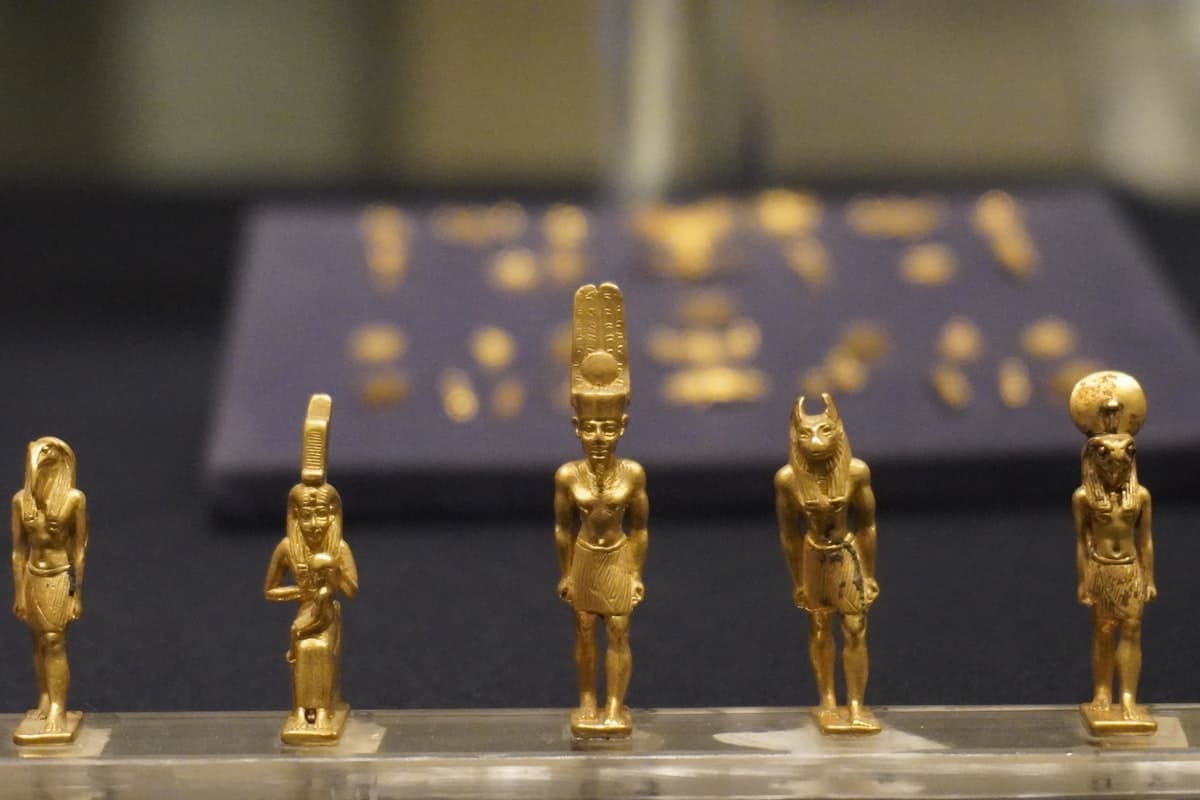 A group of gold figurines sitting on top of a table