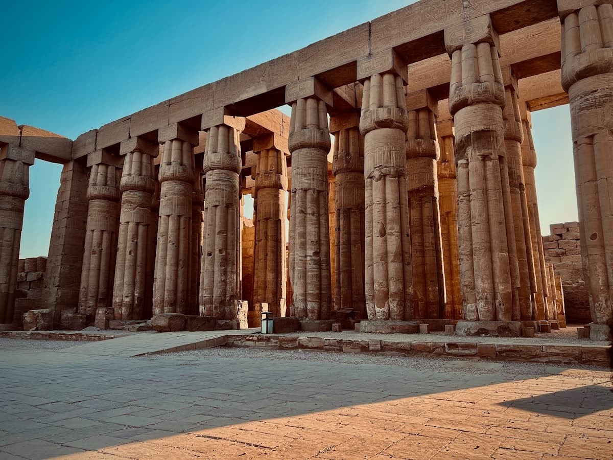 a person standing in front of a large stone structure