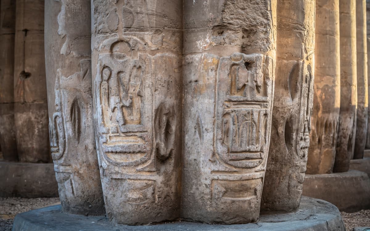 A group of stone pillars with carvings on them