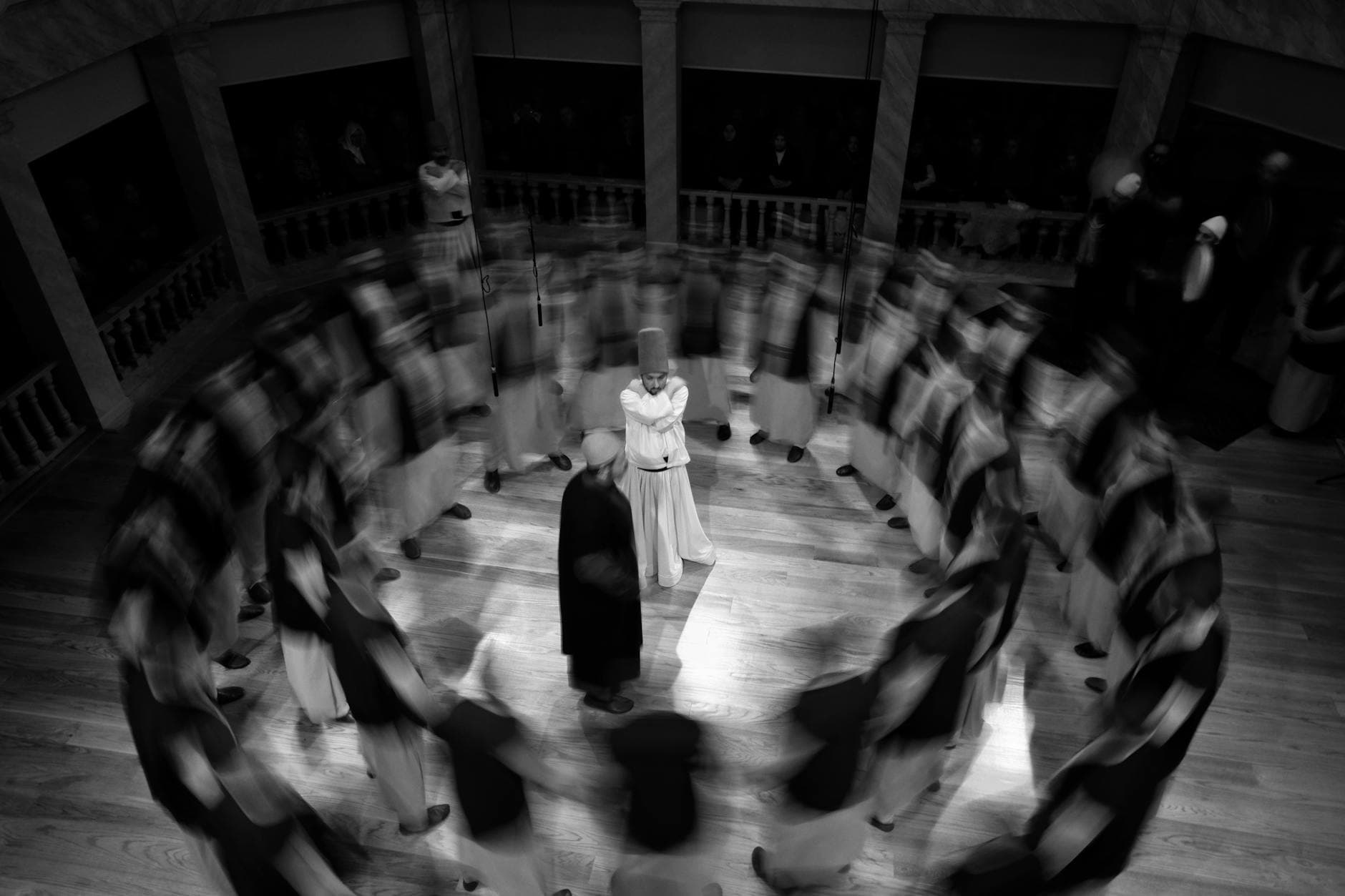 A captivating black and white image of whirling dervishes performing a traditional Sufi dance.