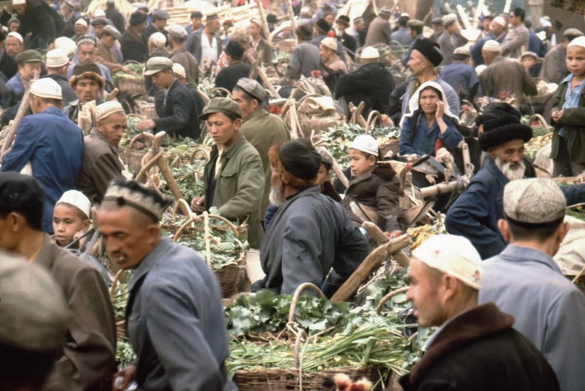 Crowded outdoor market with many people shopping