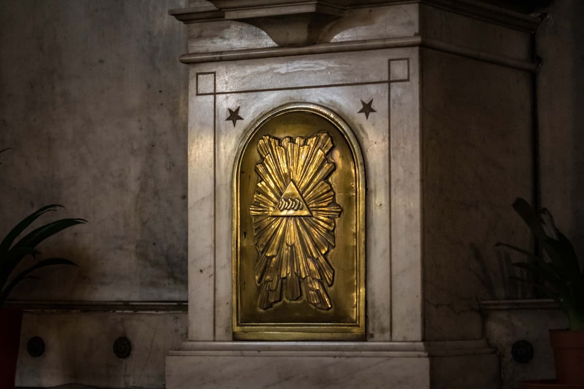 a statue of a sun with a star on it