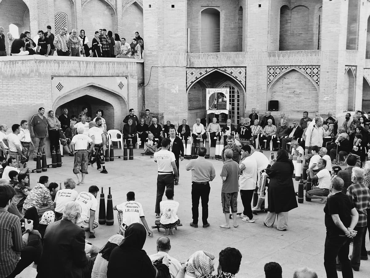 A crowd of people standing around each other in front of a building