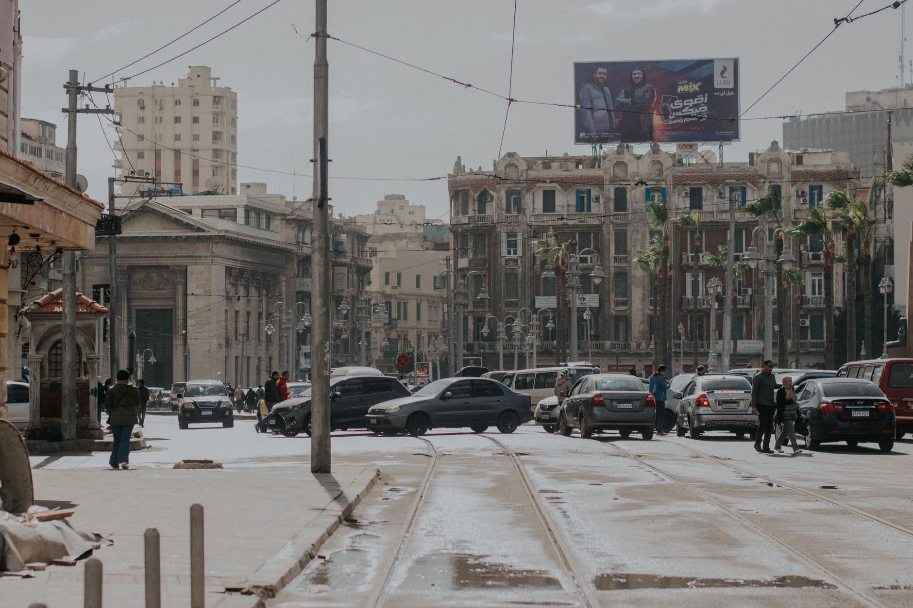 Bustling street in Alexandria, Egypt, showcasing urban life, architecture, and traffic.
