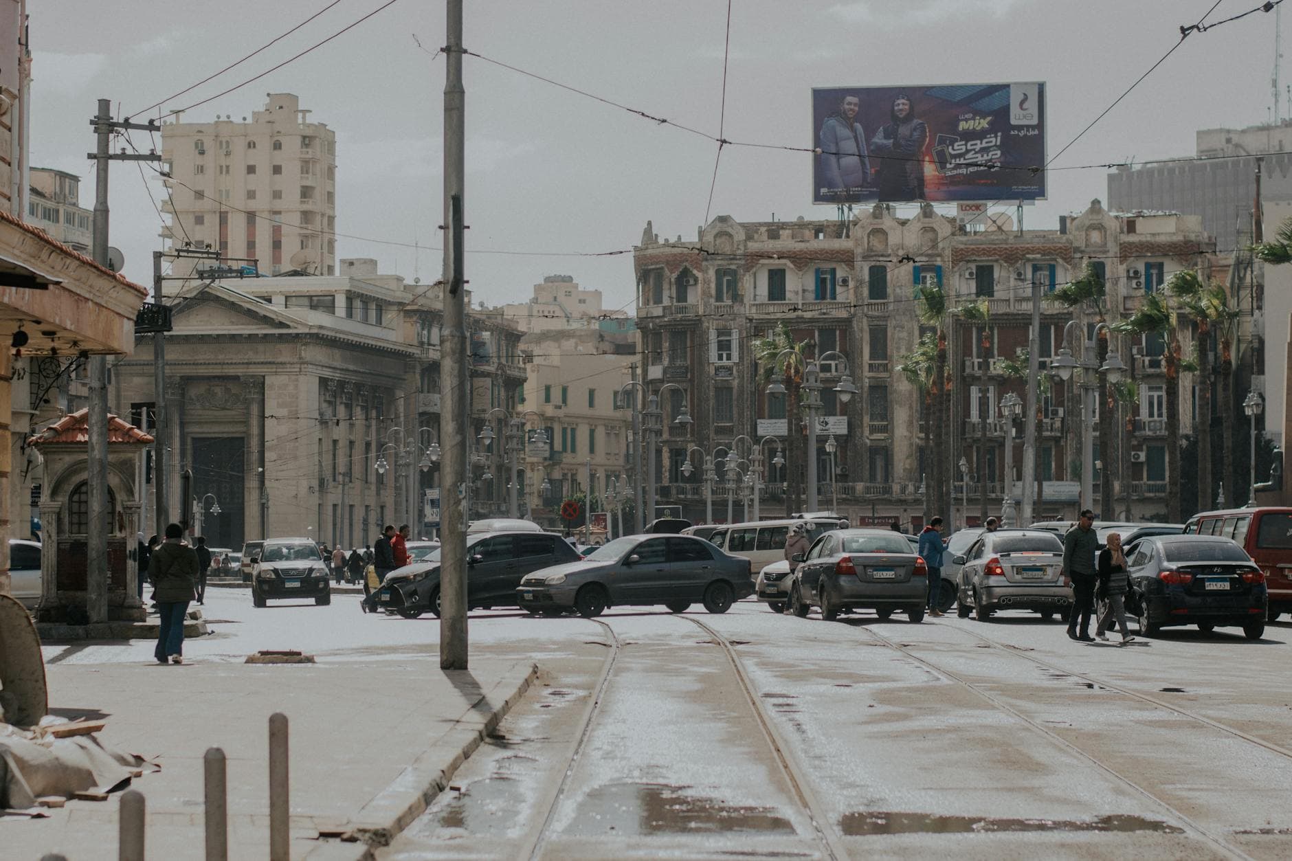 Bustling street in Alexandria, Egypt, showcasing urban life, architecture, and traffic.