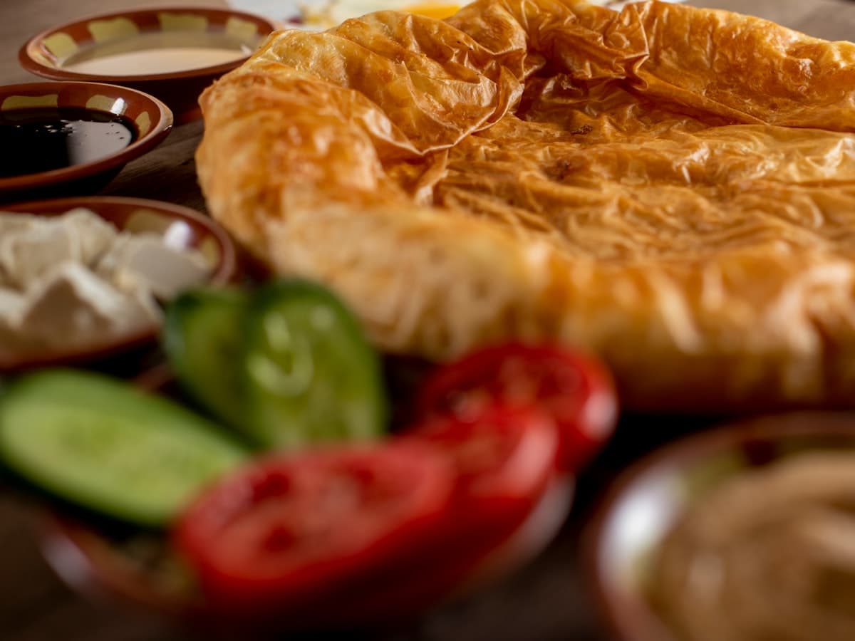 Savory pastry with fresh vegetables and dips