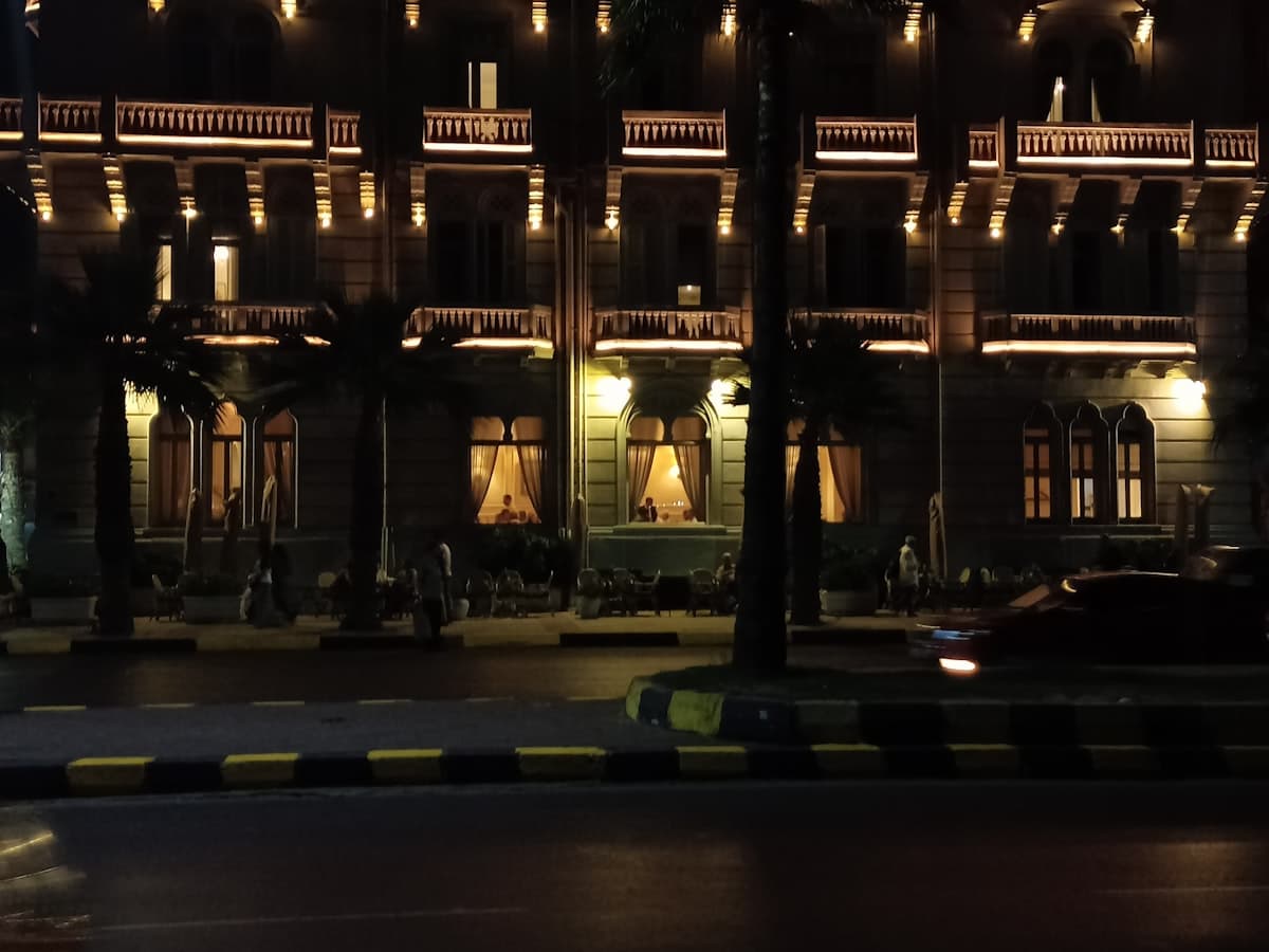 A large building lit up at night with street lights