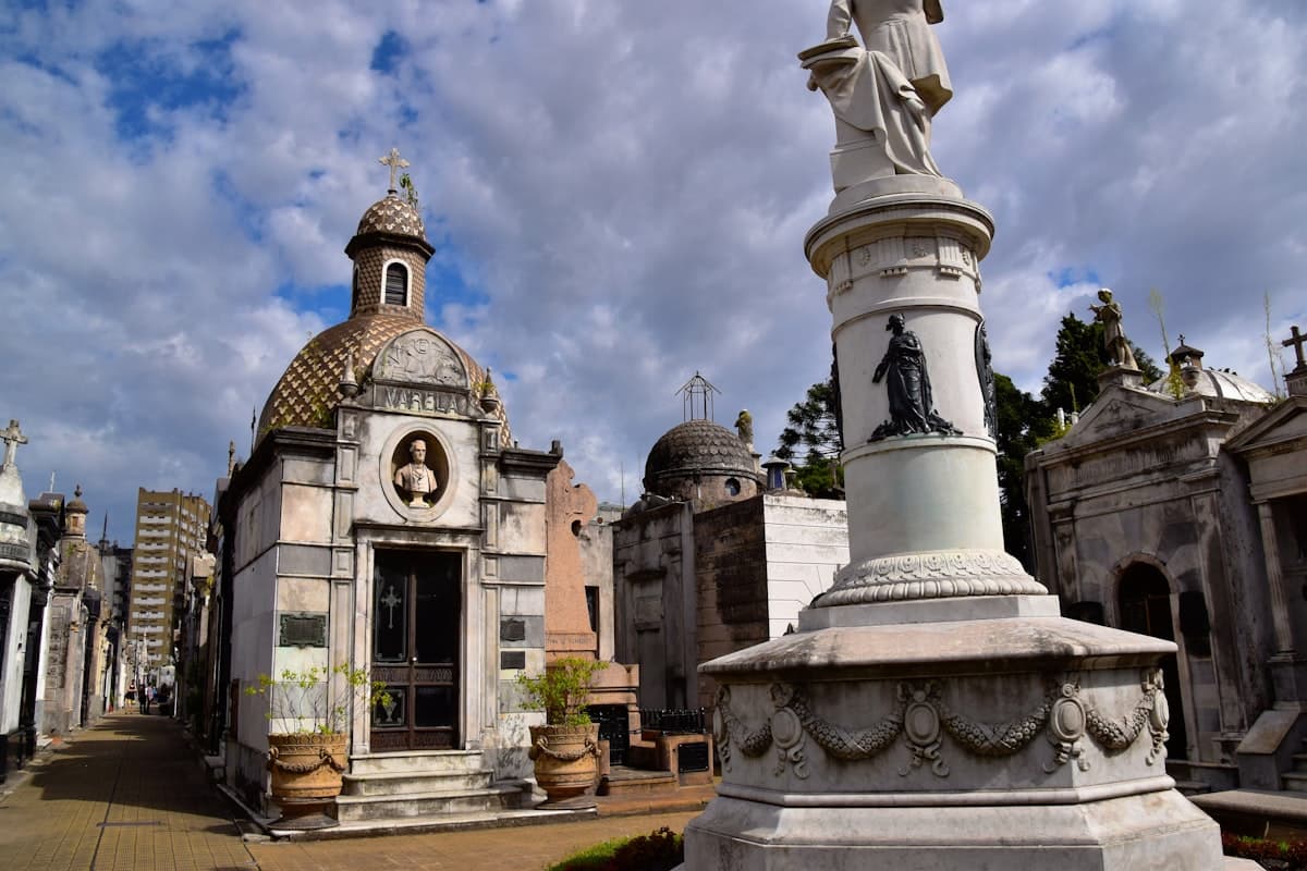 a cemetery with a statue in the middle of it