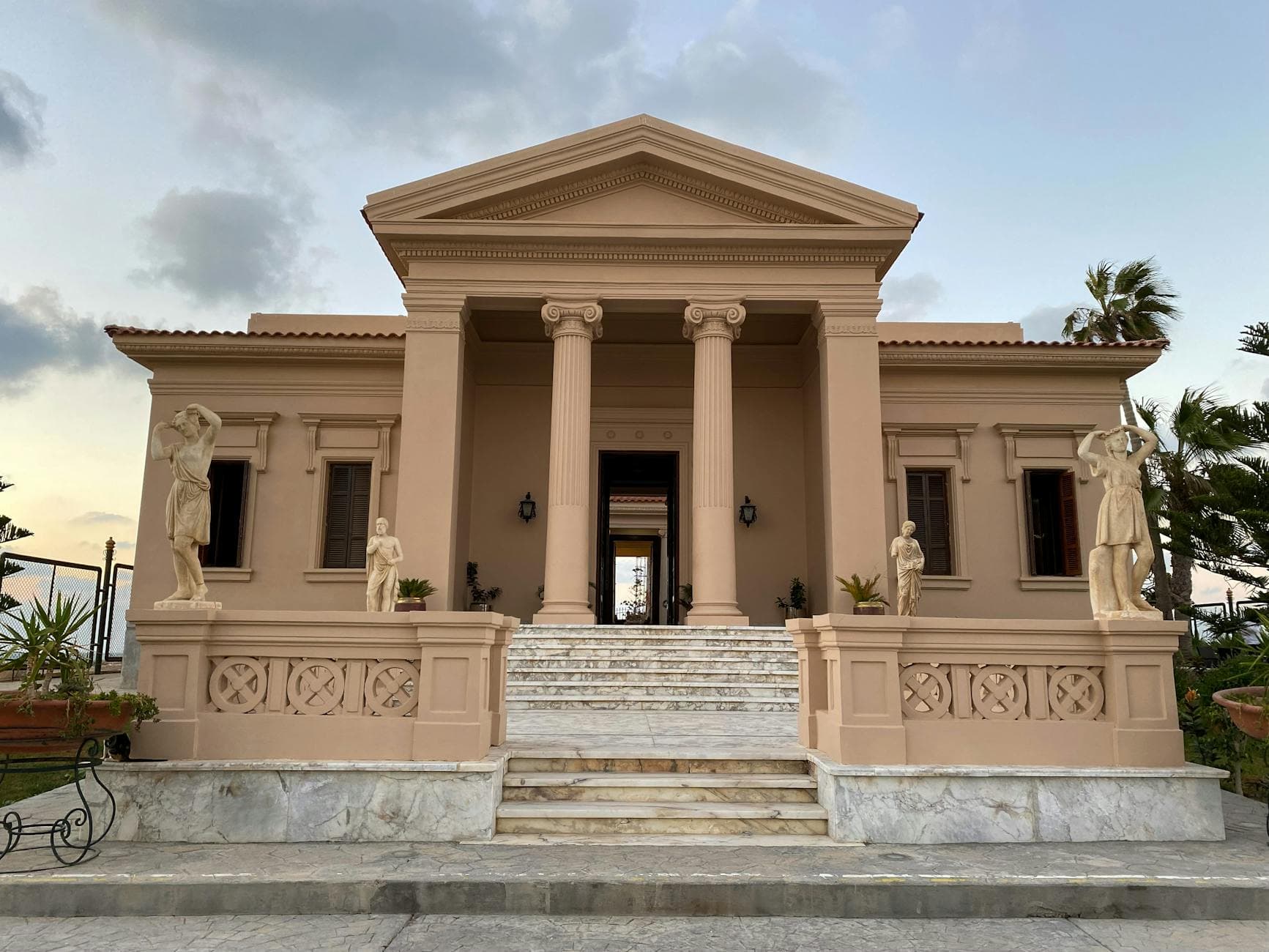 Elegant neoclassical building facade with statues in Alexandria, Egypt.